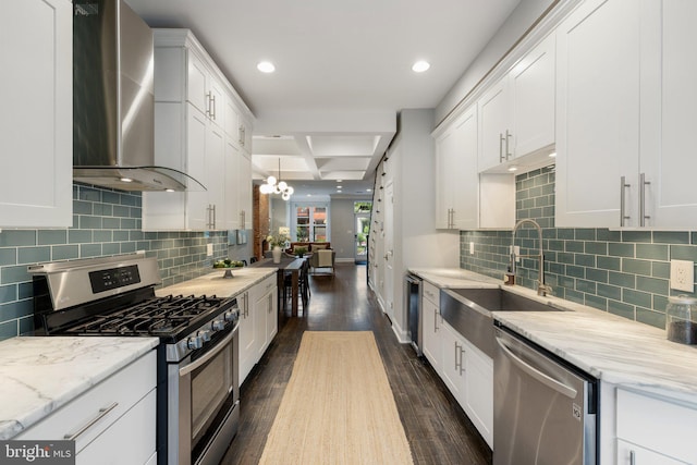 823 11th St NE, Washington, DC 20002 - kitchen featuring appliances with stainless steel finishes, wall chimney range hood, a sink, dark wood-style floors, and white cabinetry