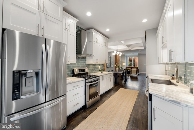 823 11th St NE, Washington, DC 20002 - kitchen featuring appliances with stainless steel finishes, wall chimney range hood, a sink, white cabinetry, and coffered ceiling
