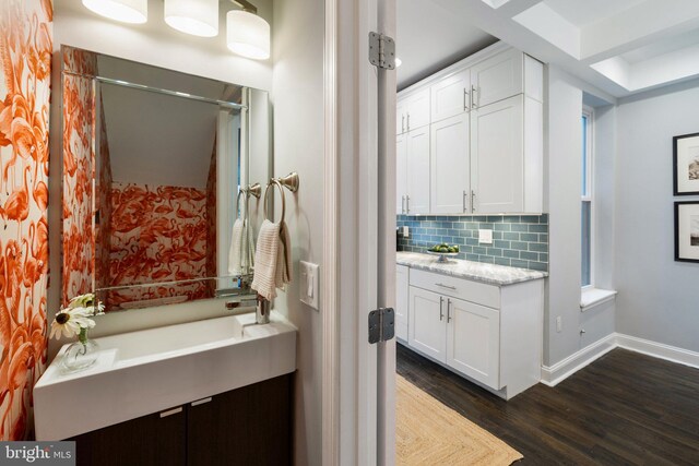 823 11th St NE, Washington, DC 20002 - full bathroom featuring wood finished floors, vanity, backsplash, baseboards, and a shower