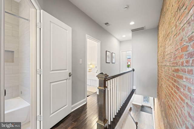 823 11th St NE, Washington, DC 20002 - hallway with an upstairs landing, dark wood-style floors, brick wall, baseboards, and recessed lighting
