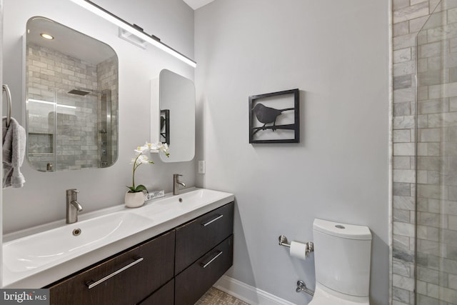 823 11th St NE, Washington, DC 20002 - bathroom with a tile shower, toilet, double vanity, and baseboards