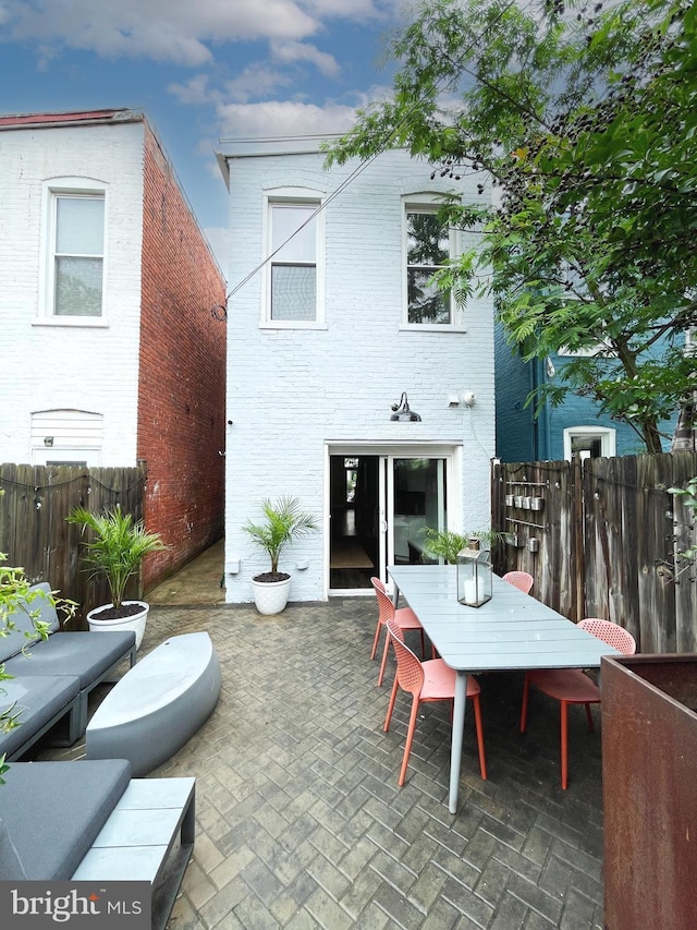 823 11th St NE, Washington, DC 20002 - back of house with outdoor dining space, a patio area, fence, and brick siding