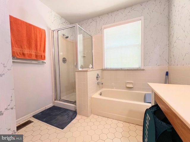 full bathroom featuring tile patterned flooring, a shower stall, a bath, vanity, and wallpapered walls