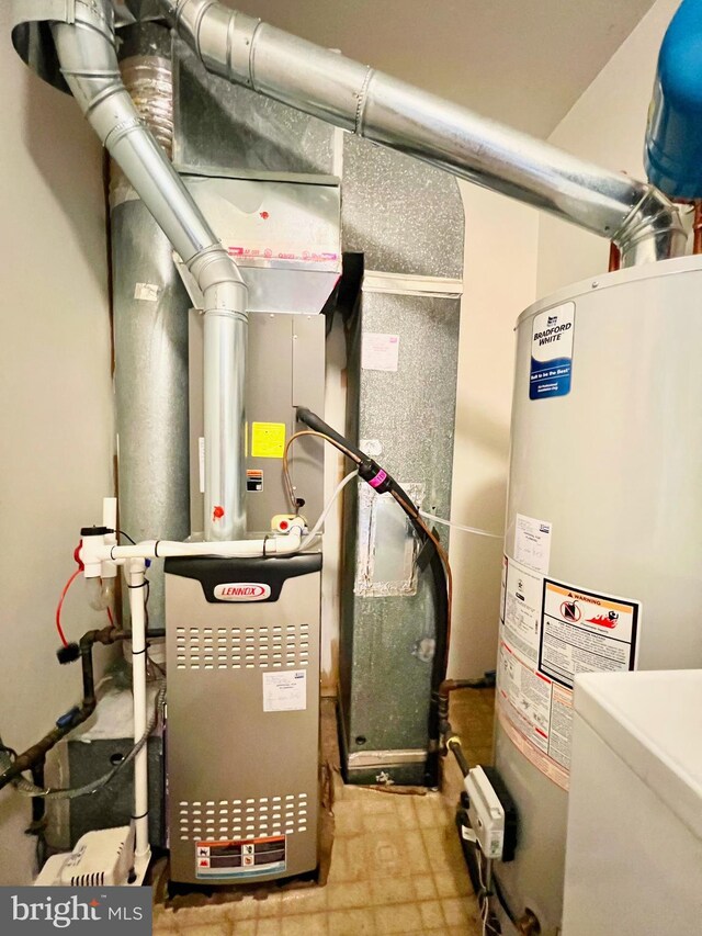 utility room featuring water heater