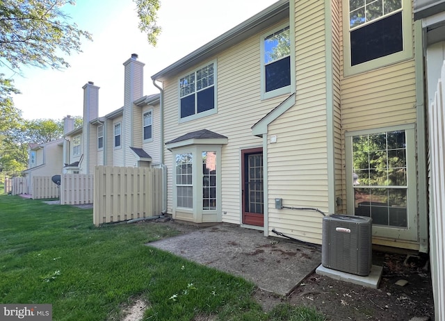 rear view of house with central AC unit