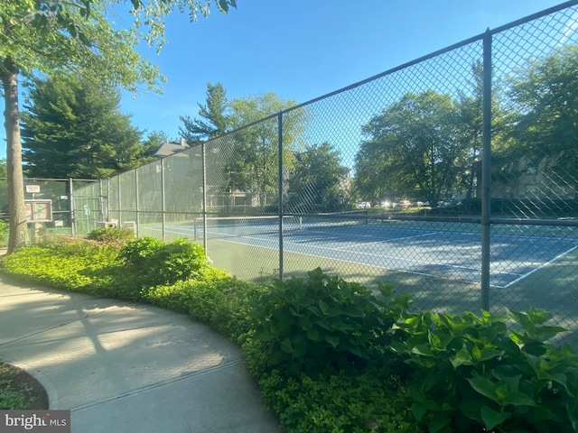 view of tennis court with fence