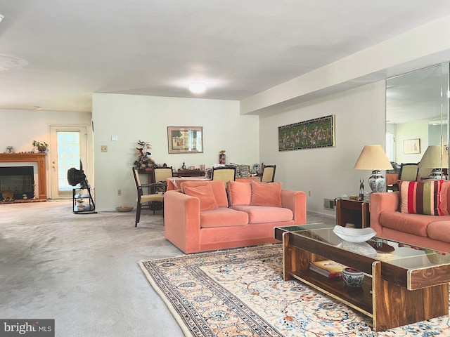 living room featuring carpet and a fireplace with raised hearth