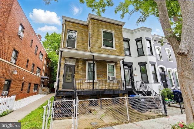1625 6th St NW, Washington, DC 20001 - multi unit property with a porch, a gate, a fenced front yard, stone siding, and cooling unit