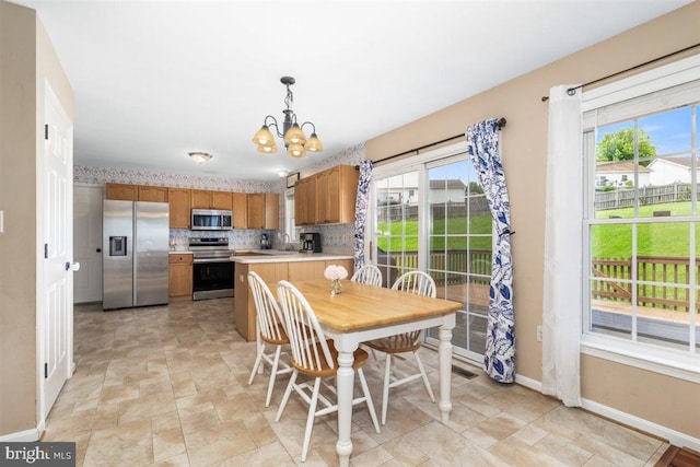 105 Bachtell Cir, Smithsburg, MD 21783 - dining area with a chandelier, baseboards, plenty of natural light, and stone finish flooring
