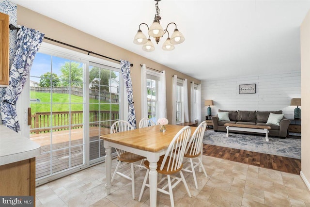 105 Bachtell Cir, Smithsburg, MD 21783 - dining room featuring a chandelier, stone finish floors, and wooden walls