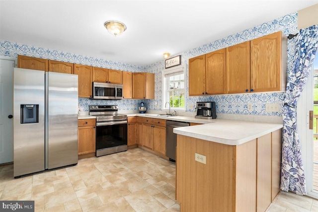 105 Bachtell Cir, Smithsburg, MD 21783 - kitchen featuring appliances with stainless steel finishes, a sink, wallpapered walls, light countertops, and a peninsula