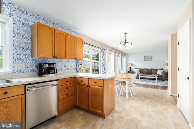 105 Bachtell Cir, Smithsburg, MD 21783 - kitchen with stainless steel dishwasher, a chandelier, light countertops, a peninsula, and wallpapered walls