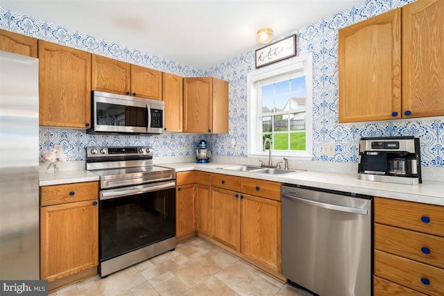 105 Bachtell Cir, Smithsburg, MD 21783 - kitchen with appliances with stainless steel finishes, a sink, wallpapered walls, light countertops, and brown cabinets