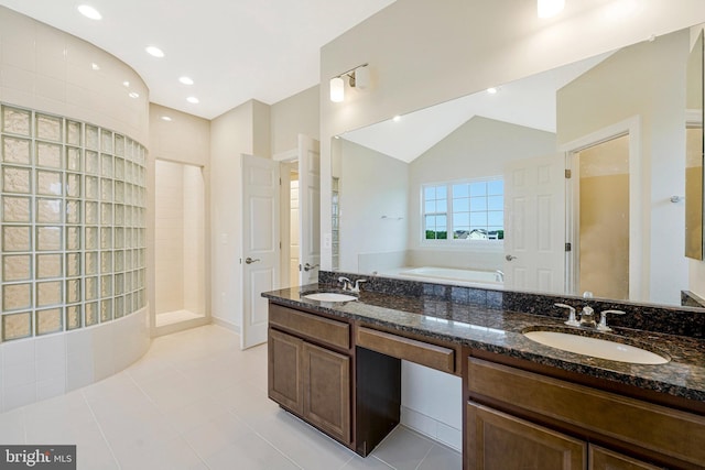42506 Black Talon Ct, Leesburg, VA 20176 - bathroom with a garden tub, tile patterned floors, double vanity, walk in shower, and vaulted ceiling
