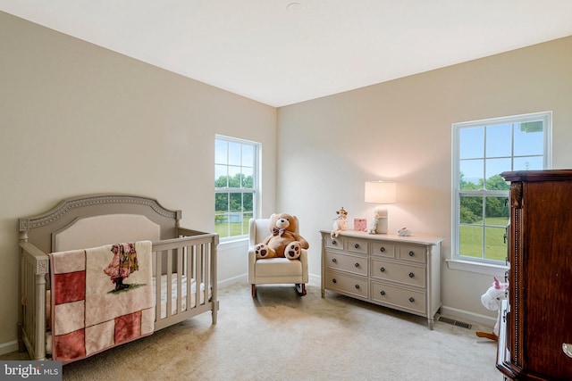 42506 Black Talon Ct, Leesburg, VA 20176 - bedroom featuring baseboards, light carpet, and a nursery area