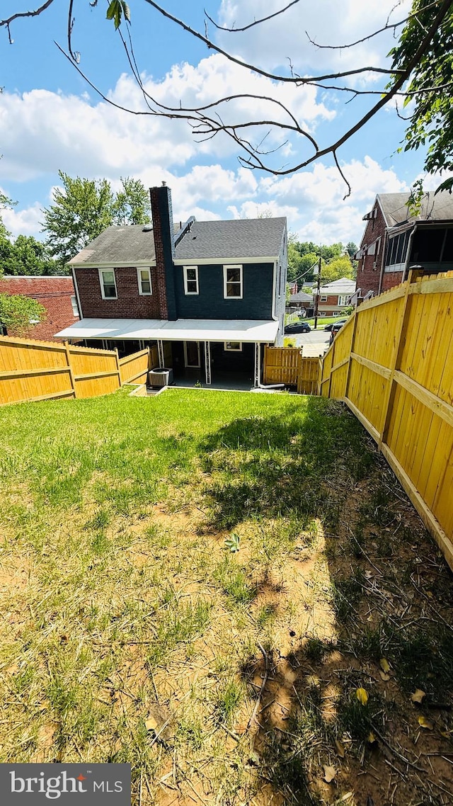 709 Adrian St SE, Washington, DC 20019 - rear view of house with a chimney and central AC