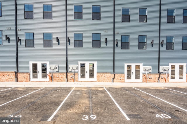 view of building exterior featuring uncovered parking
