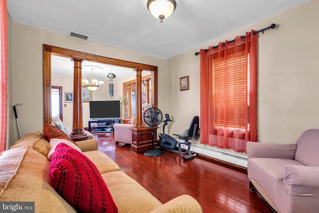 living area featuring a baseboard radiator, hardwood / wood-style floors, and a chandelier