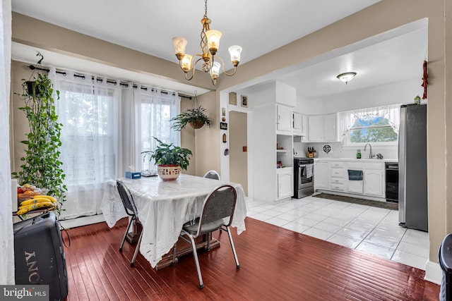 dining area with a chandelier and light wood-style flooring
