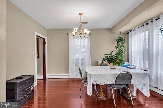 dining space with a chandelier, wood finished floors, and a baseboard heating unit