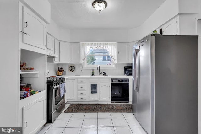 kitchen with black appliances, a sink, white cabinets, under cabinet range hood, and tasteful backsplash