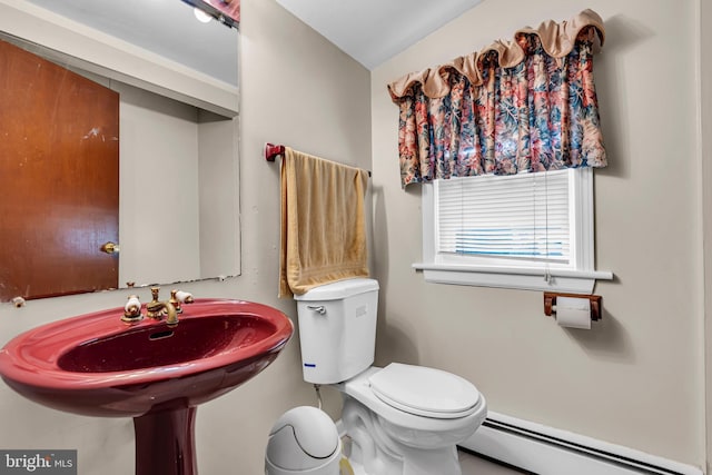 bathroom with a baseboard heating unit and toilet