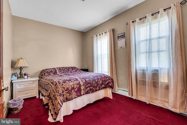 bedroom featuring dark colored carpet