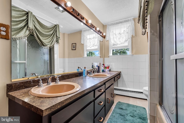 full bath with a baseboard radiator, tile walls, toilet, a shower with shower door, and tile patterned flooring