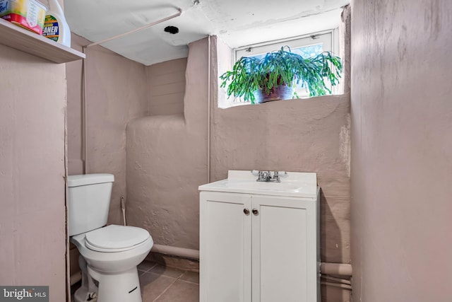 bathroom featuring toilet, tile patterned flooring, and vanity