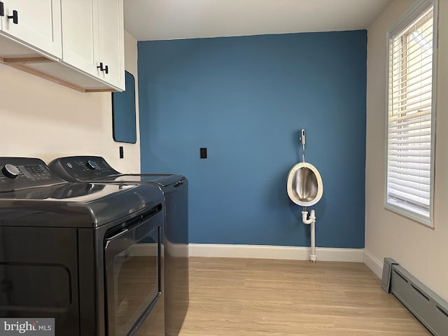 3406 Richmond St, Philadelphia, PA 19134 - washroom featuring baseboard heating, separate washer and dryer, cabinet space, light wood finished floors, and baseboards
