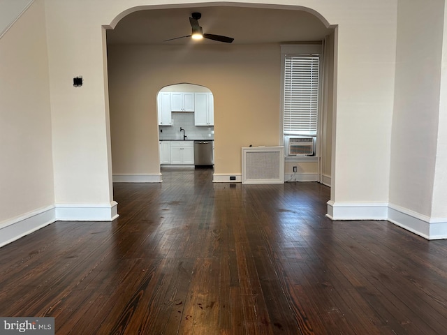 3406 Richmond St, Philadelphia, PA 19134 - spare room with ceiling fan, arched walkways, dark wood-style flooring, a sink, and radiator heating unit
