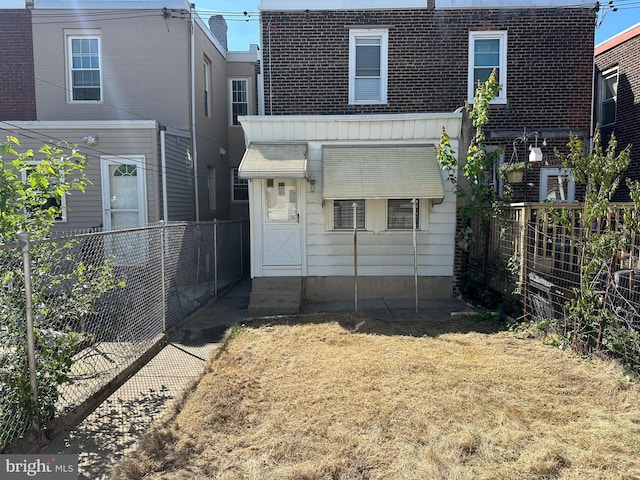 3406 Richmond St, Philadelphia, PA 19134 - back of property with mansard roof, a fenced backyard, a shingled roof, and brick siding