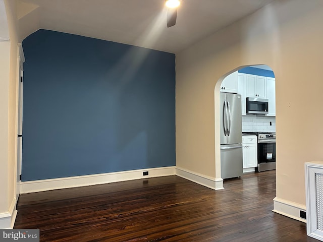 3406 Richmond St, Philadelphia, PA 19134 - empty room featuring a ceiling fan, dark wood-type flooring, baseboards, arched walkways, and vaulted ceiling