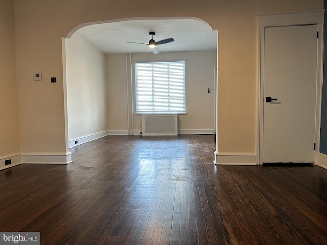 3406 Richmond St, Philadelphia, PA 19134 - unfurnished room with arched walkways, a ceiling fan, dark wood-type flooring, radiator, and baseboards