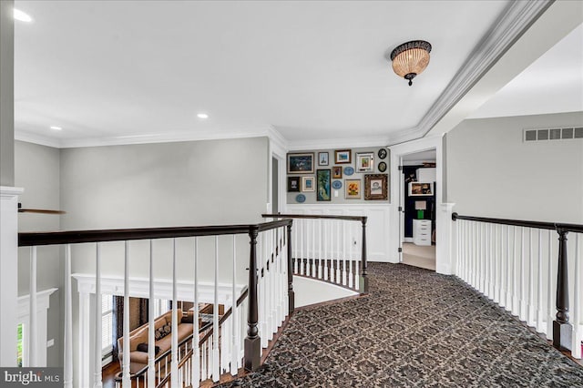 hall with an upstairs landing, ornamental molding, carpet, and recessed lighting