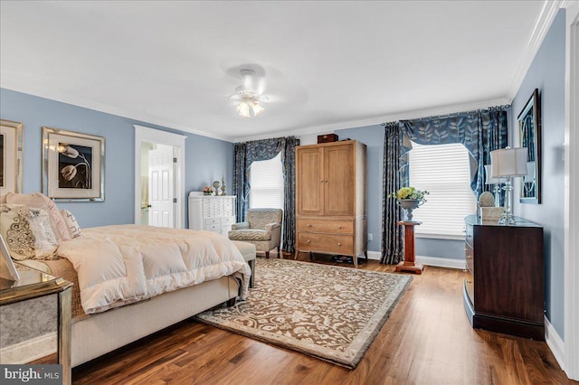 bedroom with ornamental molding, wood finished floors, and baseboards
