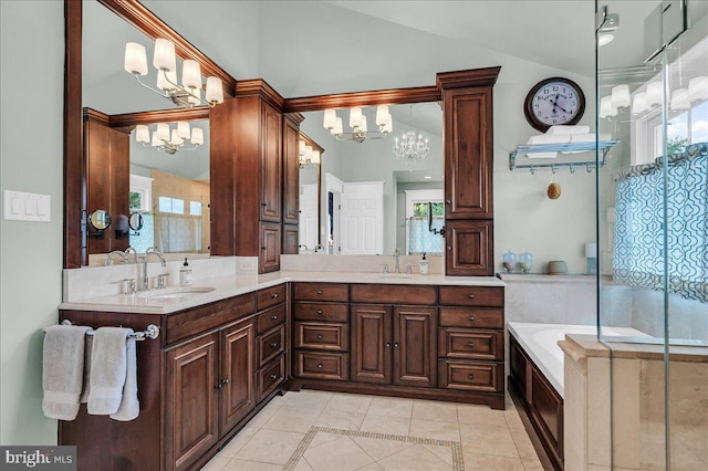 bathroom with a chandelier, lofted ceiling, inlaid floor details, tile patterned floors, and double vanity