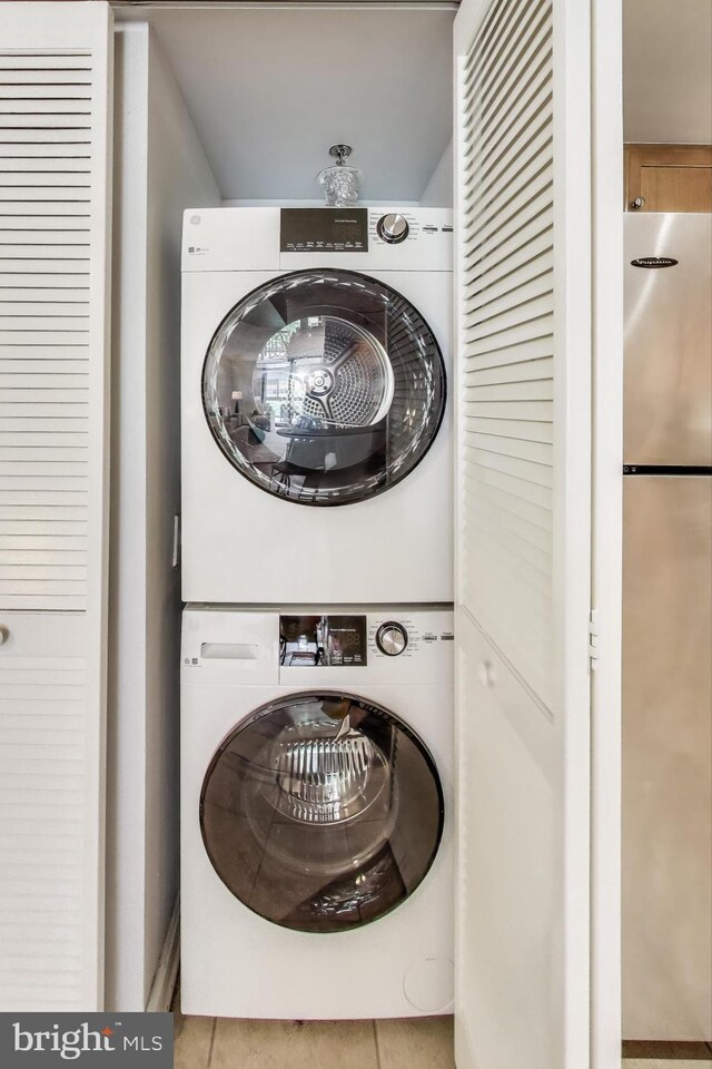 1001 N Vermont St Unit 403, Arlington, VA 22201 - laundry room featuring stacked washing machine and dryer and tile patterned flooring