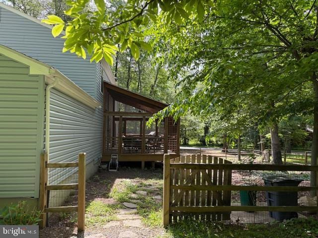 view of yard with a wooden deck and fence