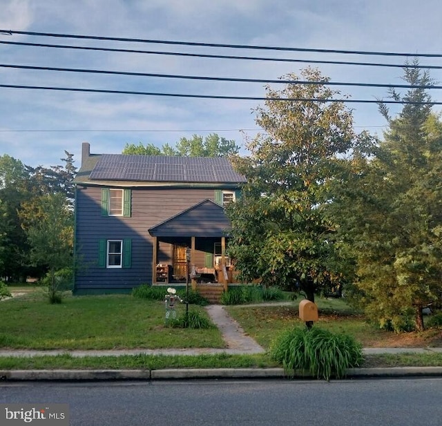 957 Main St, Port Norris, NJ 08349 - view of front of home featuring a porch, a front lawn, and a chimney