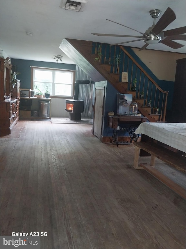 957 Main St, Port Norris, NJ 08349 - living area with a wood stove, stairs, hardwood / wood-style flooring, and ceiling fan