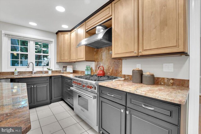6014 Marilyn Dr, Alexandria, VA 22310 - kitchen with luxury range, extractor fan, light stone countertops, a sink, and light tile patterned floors