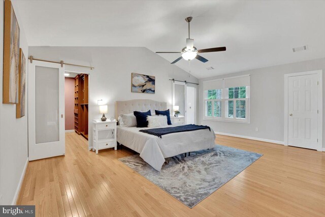 6014 Marilyn Dr, Alexandria, VA 22310 - bedroom featuring a barn door, light wood-style floors, lofted ceiling, and baseboards