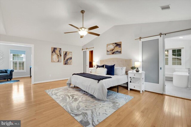 6014 Marilyn Dr, Alexandria, VA 22310 - bedroom featuring a barn door, vaulted ceiling, wood finished floors, baseboards, and ceiling fan