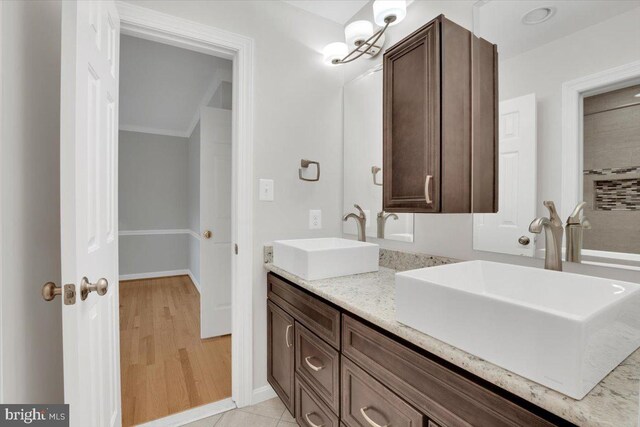 6014 Marilyn Dr, Alexandria, VA 22310 - bathroom with double vanity, ornamental molding, and wood finished floors