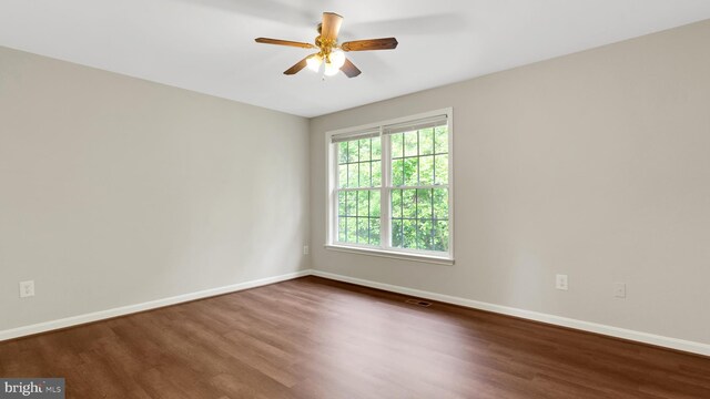 19645 Point Lookout Rd, Lexington Park, MD 20653 - empty room with dark wood-style floors, baseboards, and a ceiling fan