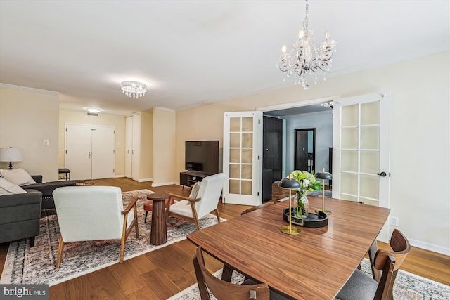 4100 Cathedral Ave NW Unit 818, Washington, DC 20016 - dining space featuring a chandelier, wood finished floors, baseboards, and crown molding