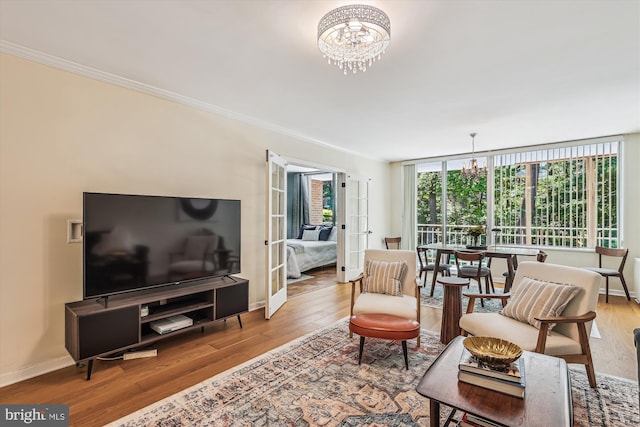4100 Cathedral Ave NW Unit 818, Washington, DC 20016 - living room featuring a chandelier, wood finished floors, ornamental molding, and baseboards