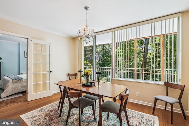 4100 Cathedral Ave NW Unit 818, Washington, DC 20016 - dining room with a chandelier, baseboards, and wood finished floors