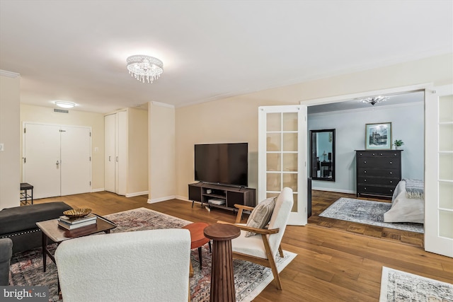 4100 Cathedral Ave NW Unit 818, Washington, DC 20016 - living area featuring wood finished floors, a chandelier, ornamental molding, and baseboards